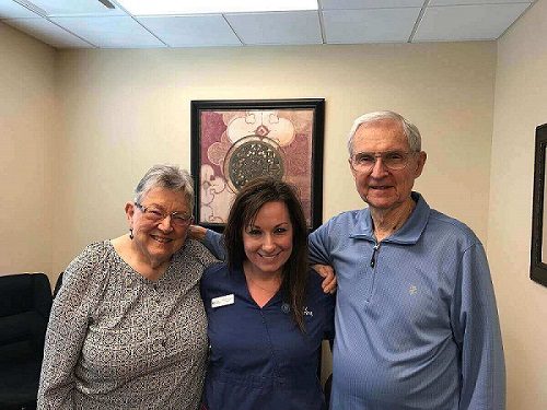 Dr. Of Audiology, Jamie Hawkins with two elderly hearing patients